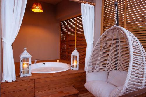 a bathroom with a hammock and a bath tub at Arwen Hotel in Fethiye