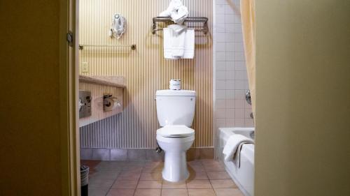 a bathroom with a toilet and a bath tub at Motel 6 - Anaheim Hills, CA in Anaheim