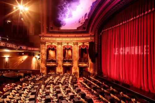 an auditorium of an opera house with red curtains at Le Capitole Hotel in Quebec City