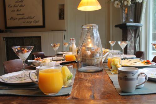 a table with a glass jar of orange juice on it at Bosgeluk in Helmond