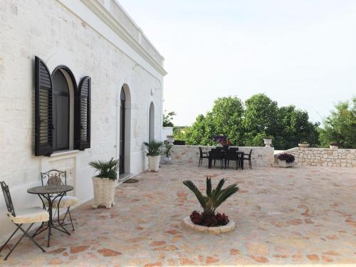 a patio outside of a building with a table and chairs at Villa Valentina in Cisternino
