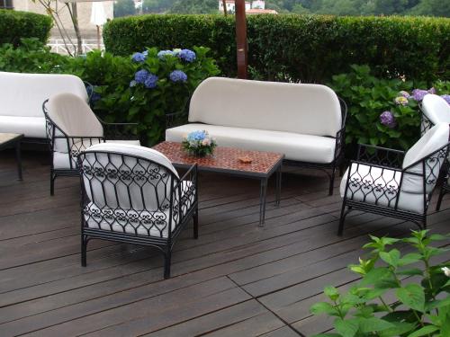 a group of chairs and tables on a patio at La Locanda Delle Donne Monache in Maratea