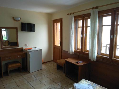 a room with a bathroom with a sink and a refrigerator at Guestrooms Durna in Sozopol