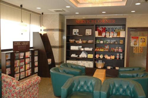 a waiting room with blue chairs in a store at Kuretake-Inn Hamamatsu Nishi I.C. in Hamamatsu