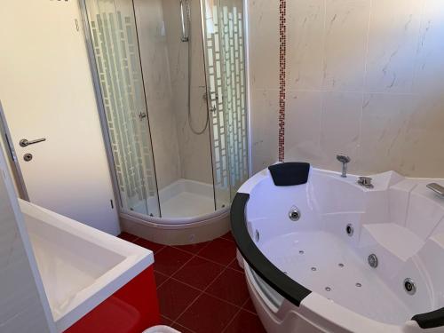 a bathroom with a white tub and a shower at Villa Mirjana in Dramalj