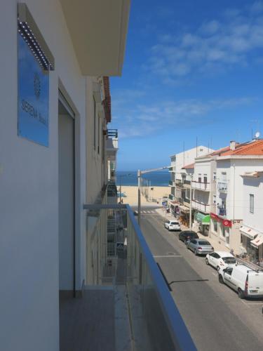 a balcony of a building with a view of a street at SERENA BEACH 3 in Nazaré