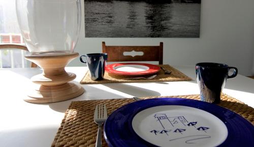 a table with a plate and a vase on it at Maison Gioffredi in Ischia