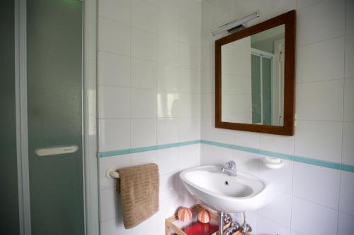 a bathroom with a sink and a mirror at Maison Gioffredi in Ischia