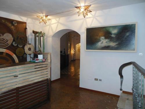 a hallway in a home with a painting on the wall at La Locanda Delle Donne Monache in Maratea