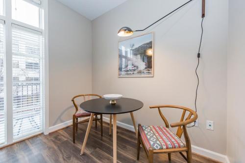 a table and two chairs in a room with a window at Mint House Nashville - Hillsboro Village in Nashville