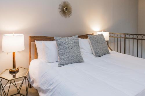 a bedroom with a white bed with two pillows at Mint House Nashville - Hillsboro Village in Nashville