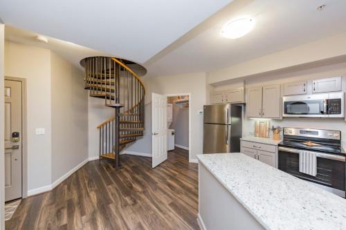 a kitchen with a spiral staircase in a house at Mint House Nashville - Hillsboro Village in Nashville