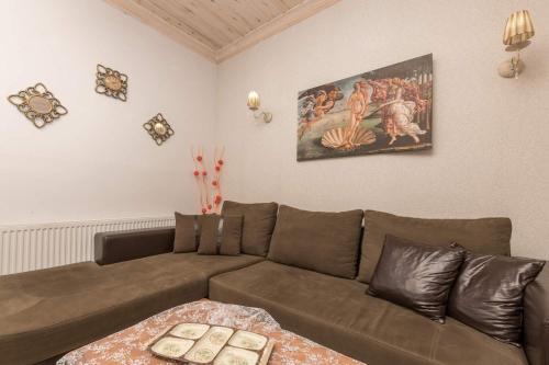 a living room with a couch and a painting on the wall at Mario's house in Kallirakhi