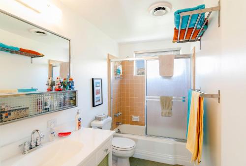 a bathroom with a shower and a toilet and a sink at The Getaway 6 in Desert Hot Springs