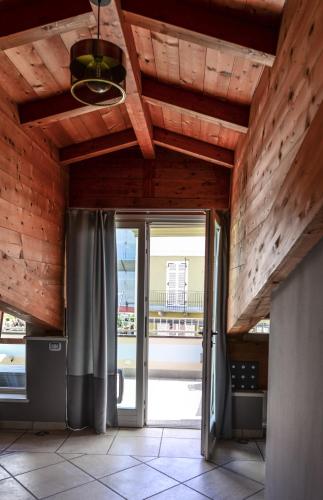 a room with a sliding glass door with a patio at Altezza in La Morra