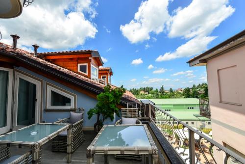 a balcony with a view of a house at Altezza in La Morra