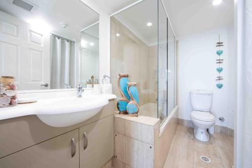 a bathroom with a sink and a toilet and a shower at 19th Avenue on the Beach in Gold Coast