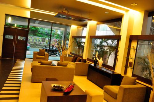 a large living room with couches and a table at Sayoojyam Residency in Palakkad
