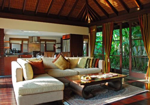 a living room with a couch and a coffee table at Gending Kedis Luxury Villas & Spa Estate in Jimbaran