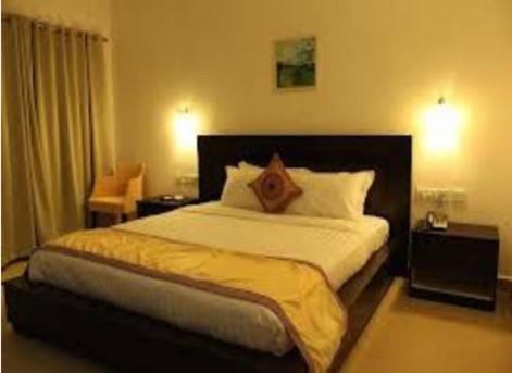 a bedroom with a large bed in a hotel room at Sayoojyam Residency in Palakkad