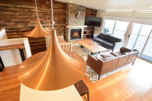 a living room with a couch and a fireplace at Apartment K2 06 AMS Mt Buller in Mount Buller