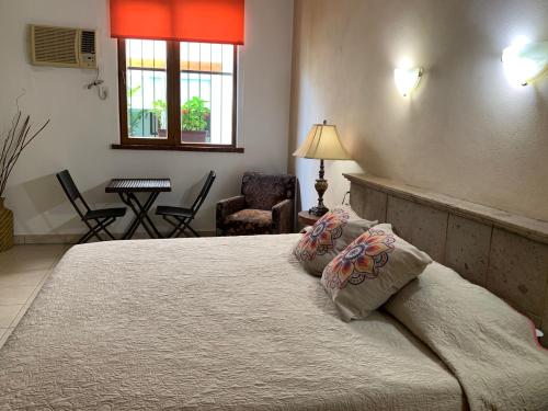 Una cama o camas en una habitación de Hotel Condominium La Posada de Bucerias