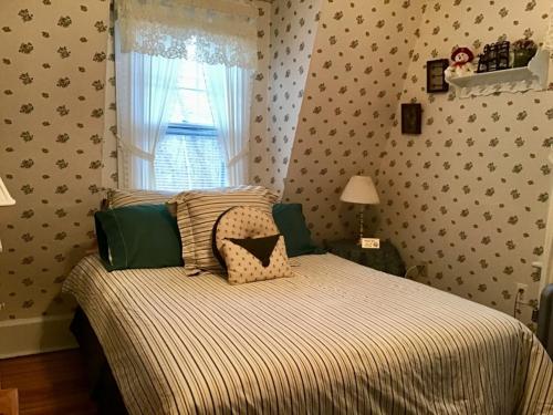 a bedroom with a bed and a window at Brookview Manor Inn in Canadensis