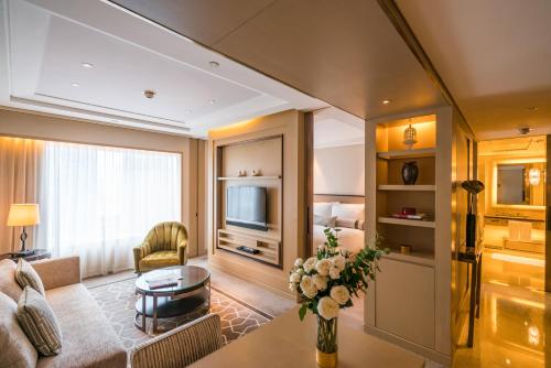 a living room with a couch and a table at IFC Residence in Shanghai