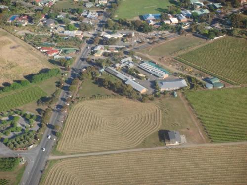 an aerial view of a farm with a road and fields at McLaren Vale Motel & Apartments in McLaren Vale