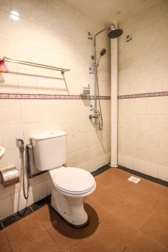 a bathroom with a toilet and a shower at Rose Cottage Hotel Taman Johor Jaya in Johor Bahru