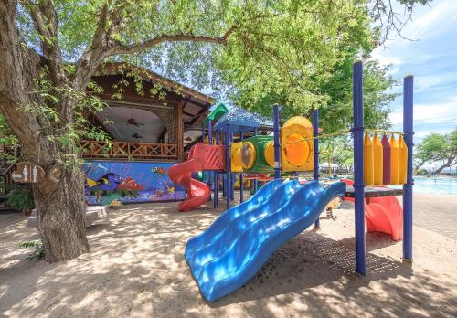 a playground with a slide next to a tree at Regent - Chalet, Hua Hin in Cha Am