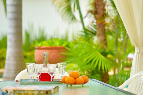 a table with glasses of juice and oranges on it at Sweet Villas Pattaya in Pattaya South