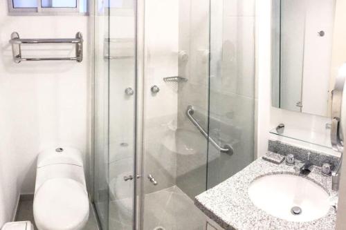 uma casa de banho com um chuveiro, um WC e um lavatório. em Apartamento cómodo en la ciudad bonita em Bucaramanga