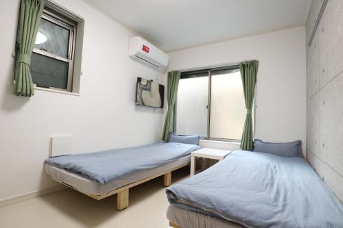 Łóżko lub łóżka w pokoju w obiekcie Tokyo Sakura hotel