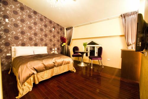 a bedroom with a bed and a desk in a room at Formosa Vacation Village Homestay in Renai