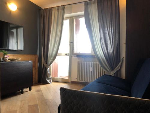 a bedroom with a bed and a large window at Royal in Sestriere