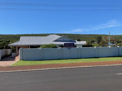 a white fence in front of a house at Beachside Prevelly Villas in Prevelly