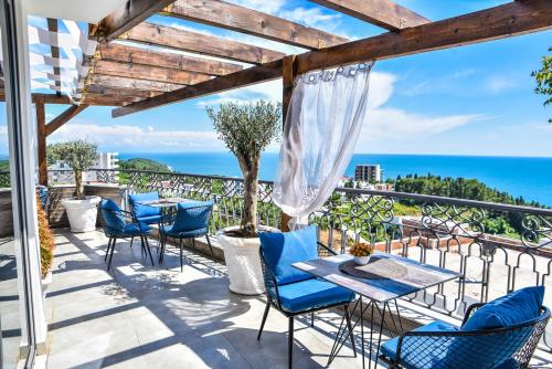 a patio with a table and chairs and the ocean at Padam Hotel & SPA in Ulcinj