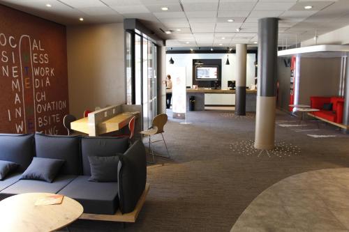 a waiting room with a couch and a table at ibis Toulouse Centre in Toulouse