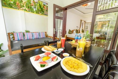 a table with plates of food on top of it at An Bang Coco Villa in Hoi An
