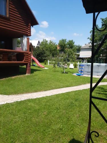 a yard with a playground and a slide at "Карпатський краєвид" in Polyana