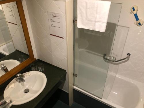 a bathroom with a shower and a sink and a showerspective at Marina de Campios in Comillas