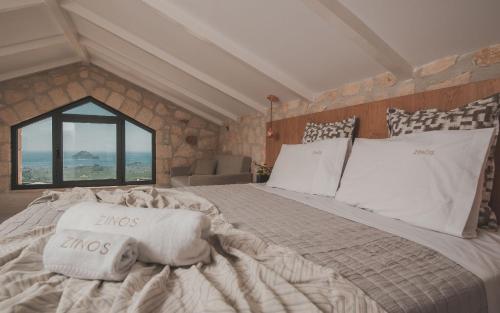 a large bed in a room with a window at Zinos Luxury Villa in Lithakia