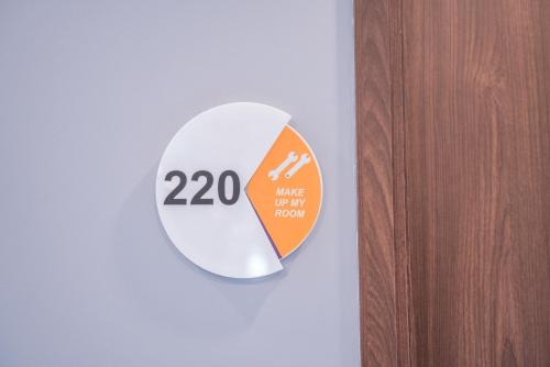 a sign on a door with the number on it at All Nite & Day Kebon Jeruk in Jakarta