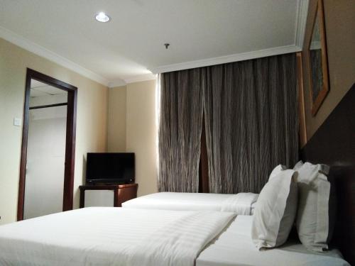 Katil atau katil-katil dalam bilik di Kinabalu Daya Hotel
