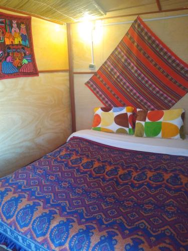 Ένα ή περισσότερα κρεβάτια σε δωμάτιο στο Uros Lodge Lover Titiqaqa