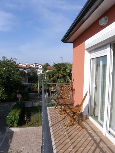 a wooden bench sitting on the balcony of a house at Apartments Nina in Umag