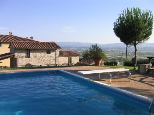 a swimming pool in front of a house at Hotel Relais Palazzo di Luglio in Sansepolcro