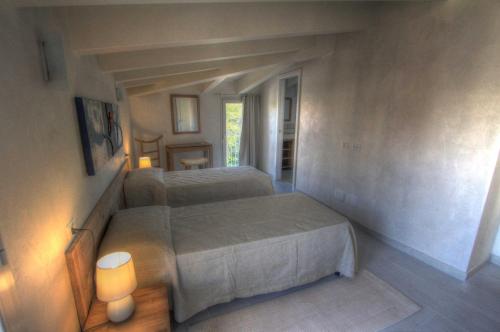 a bedroom with two beds in a small room at La casa di Pier in Olbia