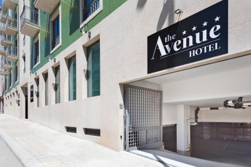 a building with a sign that reads the avenue hotel at Acta The Avenue in Porto
